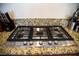 Granite countertops highlight the modern, built-in gas cooktop at 4384 Grey Spencer Dr, Las Vegas, NV 89141