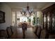 Formal dining room featuring a large table, elegant chandelier, and decorative furnishings at 4384 Grey Spencer Dr, Las Vegas, NV 89141