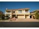 Stunning two-story home featuring a tile roof, dual balconies, and a three-car garage at 4384 Grey Spencer Dr, Las Vegas, NV 89141