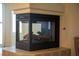 Modern fireplace with tile surround, black metal accents, and gas logs at 4384 Grey Spencer Dr, Las Vegas, NV 89141