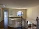 Bright foyer with a curved railing overlooking the main level, chandelier, and a large window at 4384 Grey Spencer Dr, Las Vegas, NV 89141