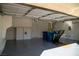 Spacious garage featuring epoxy flooring, overhead storage, and a workout area, perfect for parking and recreational activities at 4384 Grey Spencer Dr, Las Vegas, NV 89141