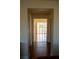 Hallway leading to a bright room with large windows and hardwood flooring at 4384 Grey Spencer Dr, Las Vegas, NV 89141