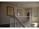 Upstairs hallway featuring stylish artwork and a view into a bedroom, creating a welcoming atmosphere at 4384 Grey Spencer Dr, Las Vegas, NV 89141