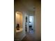 Hallway featuring a decorative niche with a vase and an open doorway to a bedroom, enhancing the home's charm at 4384 Grey Spencer Dr, Las Vegas, NV 89141