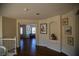 Inviting hallway with hardwood floors, curved staircase, and arched display niche adds elegance at 4384 Grey Spencer Dr, Las Vegas, NV 89141