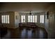 Bright living room with shuttered windows, hardwood floors, and decorative seating arrangement at 4384 Grey Spencer Dr, Las Vegas, NV 89141