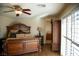 This is the main bedroom featuring a decorative ceiling fan, beautiful furniture, and natural light through the window at 4384 Grey Spencer Dr, Las Vegas, NV 89141