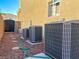 Side yard with air conditioning units, rock landscaping and brick pavers at 4384 Grey Spencer Dr, Las Vegas, NV 89141