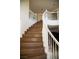 Elegant staircase with wooden steps and a white curved banister at 4384 Grey Spencer Dr, Las Vegas, NV 89141