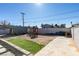 Backyard featuring a playground, large lot, partial turf, and a concrete patio at 4505 Providence Ln, Las Vegas, NV 89107