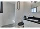 Bathroom featuring updated vanity, tiled shower and black hardware at 4505 Providence Ln, Las Vegas, NV 89107