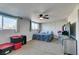 Spacious bedroom with carpet flooring, a ceiling fan, and natural light from two windows at 4505 Providence Ln, Las Vegas, NV 89107