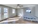 Bright bedroom featuring a ceiling fan, wood-look flooring, and a double glass door at 4505 Providence Ln, Las Vegas, NV 89107