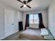 Bedroom with carpet flooring, small window with curtains, and a storage closet at 4505 Providence Ln, Las Vegas, NV 89107