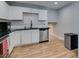 Well-lit kitchen with white cabinets, stainless steel dishwasher, and black countertops at 4505 Providence Ln, Las Vegas, NV 89107