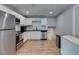 Modern kitchen features stainless steel appliances, white cabinets, and wood-look floors at 4505 Providence Ln, Las Vegas, NV 89107