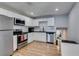 Bright kitchen with stainless steel appliances, white cabinets, and an open floor plan at 4505 Providence Ln, Las Vegas, NV 89107