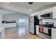 Open kitchen and living area with stainless steel appliances, white subway tile backsplash, and lots of counter space at 4505 Providence Ln, Las Vegas, NV 89107