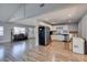 Expansive living area with wood floors, stainless steel appliances, and white cabinetry at 4505 Providence Ln, Las Vegas, NV 89107