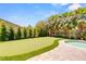 Backyard featuring tropical landscaping, a putting green, waterfall, and stone patio at 4542 Grey Spencer Dr, Las Vegas, NV 89141