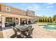 Exterior view featuring an outdoor dining area, tropical landscaping, and pool with waterfall at 4542 Grey Spencer Dr, Las Vegas, NV 89141