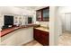 A custom bar area includes a sink, rich wood cabinetry, and seamless transition to the living area at 4542 Grey Spencer Dr, Las Vegas, NV 89141