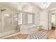 Bathroom featuring a glass shower, jetted tub, columns, and decorative glass block at 4542 Grey Spencer Dr, Las Vegas, NV 89141