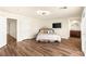 Spacious bedroom featuring vinyl floors, a television, and a mini bar at 4542 Grey Spencer Dr, Las Vegas, NV 89141