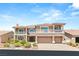 Elegant two-story home boasts dual balconies, a three-car garage, and manicured landscaping at 4542 Grey Spencer Dr, Las Vegas, NV 89141