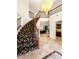 Foyer with a sweeping staircase, elegant chandelier, and view to dining area at 4542 Grey Spencer Dr, Las Vegas, NV 89141