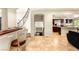 Foyer with a staircase, tile flooring, access to kitchen, and view to lower level at 4542 Grey Spencer Dr, Las Vegas, NV 89141