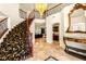 Spacious foyer featuring a curved staircase, decorative chandelier, tile flooring, and an ornate mirror at 4542 Grey Spencer Dr, Las Vegas, NV 89141