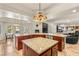 Open kitchen featuring granite counters, double islands, stainless steel appliances, and an ornate stained glass pendant light at 4542 Grey Spencer Dr, Las Vegas, NV 89141
