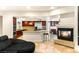 Open concept kitchen with granite countertops, stainless steel appliances, and a cozy fireplace at 4542 Grey Spencer Dr, Las Vegas, NV 89141