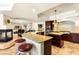 Gourmet kitchen with granite counters, stainless appliances, a large island, and adjacent living space with fireplace at 4542 Grey Spencer Dr, Las Vegas, NV 89141