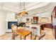 Open kitchen and dining area with fireplace and unique pendant lighting, perfect for entertaining at 4542 Grey Spencer Dr, Las Vegas, NV 89141
