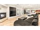 Cozy living room with a fireplace, built-in cabinets, tile flooring, and access to the outdoor patio at 4542 Grey Spencer Dr, Las Vegas, NV 89141