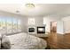 Large main bedroom with hardwood floors, fireplace, chandelier, and ample natural light at 4542 Grey Spencer Dr, Las Vegas, NV 89141
