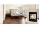 Inviting main bedroom featuring hardwood floors, fireplace, and a large window for natural light at 4542 Grey Spencer Dr, Las Vegas, NV 89141