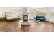 Spacious main bedroom with a fireplace, wood floors, sitting area, and natural light at 4542 Grey Spencer Dr, Las Vegas, NV 89141