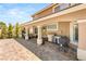 Covered outdoor kitchen with stainless steel grill and brick flooring at 4542 Grey Spencer Dr, Las Vegas, NV 89141