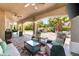 Spacious covered patio with outdoor seating, kitchen, and pool view at 4542 Grey Spencer Dr, Las Vegas, NV 89141