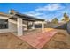 Backyard featuring desert landscaping, a concrete and brick patio, and a covered patio structure at 4769 Via Renaldo, Las Vegas, NV 89103