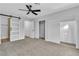 Spacious bedroom featuring a ceiling fan, modern sliding closet doors, and updated ensuite entrance at 4769 Via Renaldo, Las Vegas, NV 89103