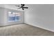 Bedroom featuring neutral carpet, a ceiling fan, and a window at 4769 Via Renaldo, Las Vegas, NV 89103