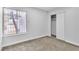 Bedroom featuring neutral carpet, a window, and a closet with sliding doors at 4769 Via Renaldo, Las Vegas, NV 89103