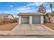 Front view of a house with a gray roll-up garage door and a carport at 4769 Via Renaldo, Las Vegas, NV 89103