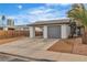 View of a house featuring a carport and a gray roll-up garage door at 4769 Via Renaldo, Las Vegas, NV 89103