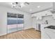 Modern kitchen featuring white cabinets and a stainless-steel hood and a sliding glass door at 4769 Via Renaldo, Las Vegas, NV 89103